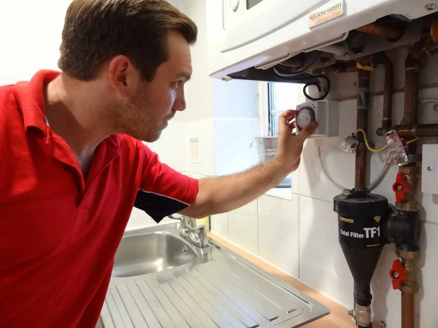 Chiswick Plumbers 247 boiler repair engineer working on a boiler in Chiswick